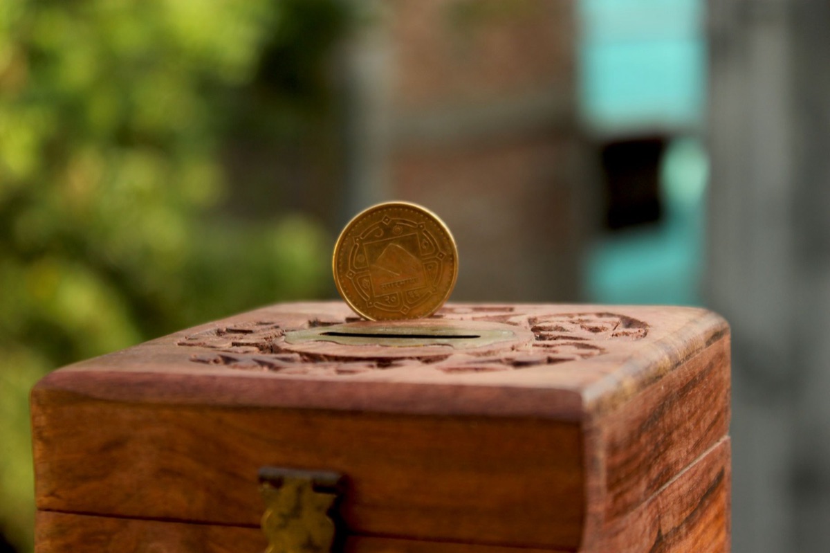 seychelles rupee coin on wooden surface