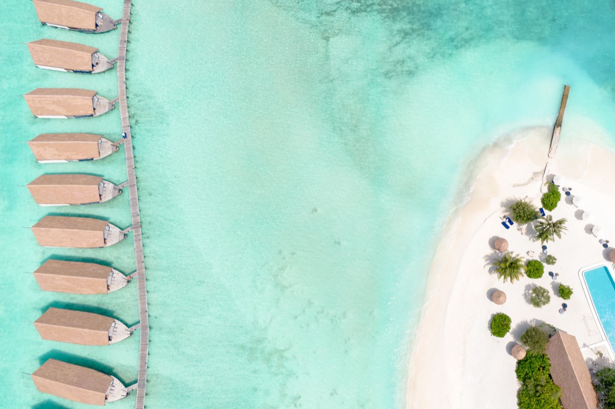 maldives resort with infinity pool and turquoise lagoon