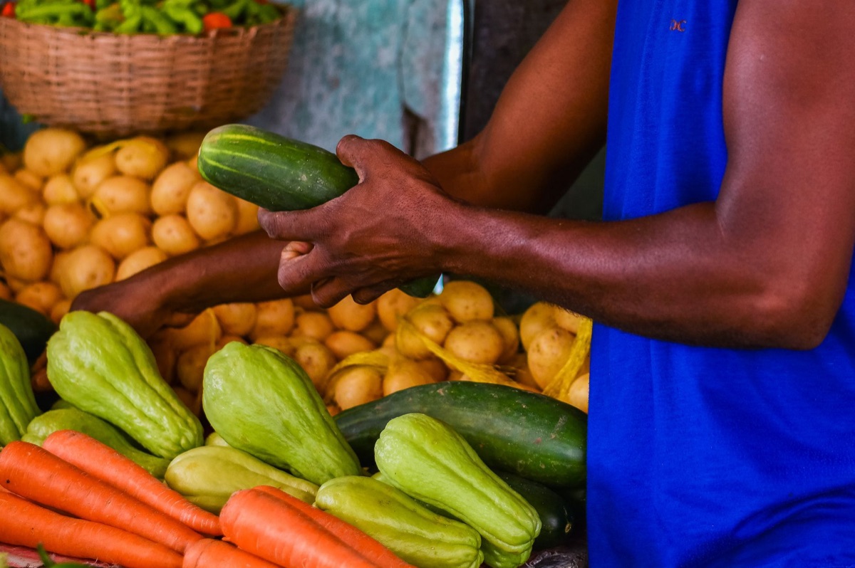 seychelles creole market vendor with traditional goods