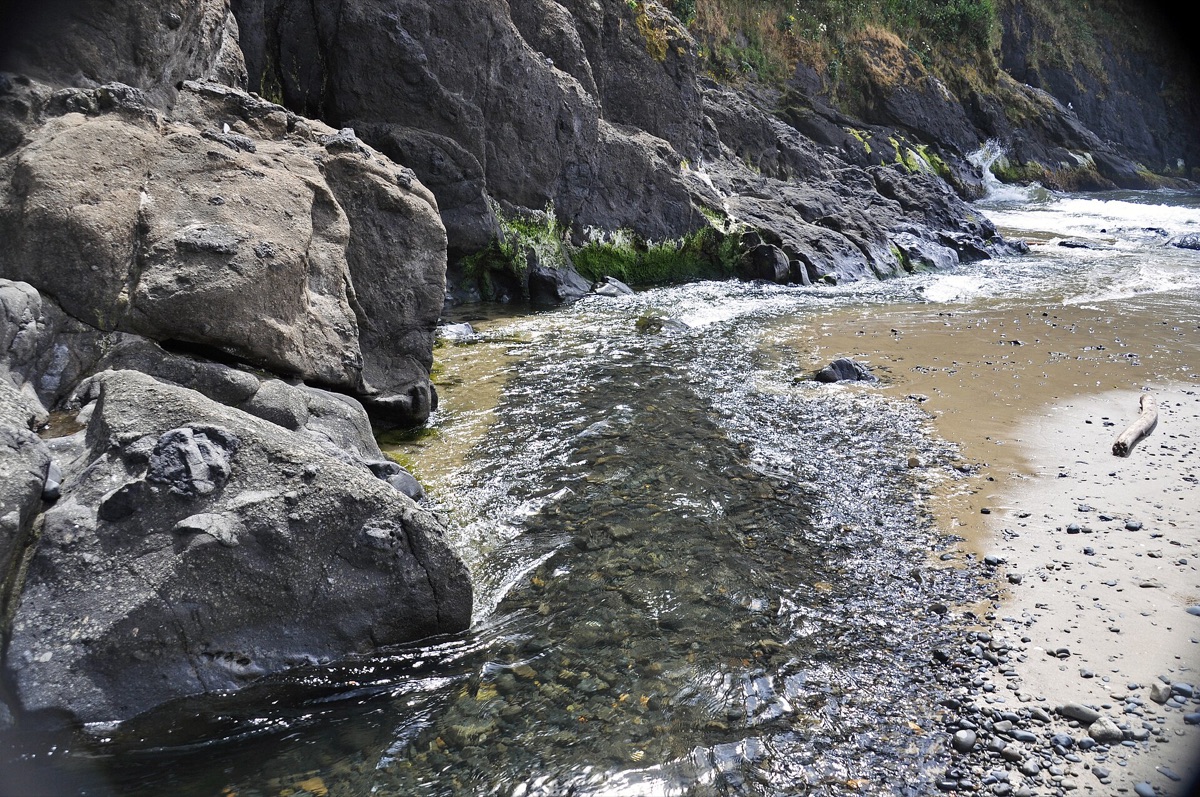 Sandy beach with basalt rocks
